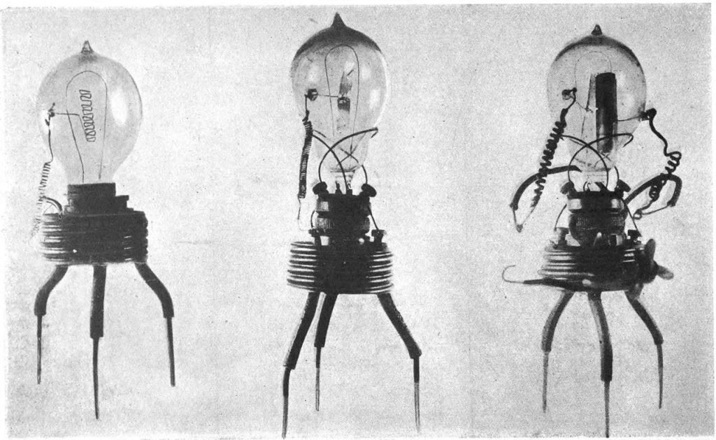 “Three vintage vacuum tubes with various internal structures, mounted on stands with visible wiring and components.” [AI-generated description, which I love!]
