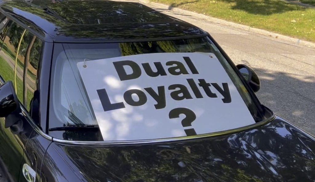 a sign reading "DUAL LOYALTY?" posted outside a synagogue in Ann Arbor, MI
