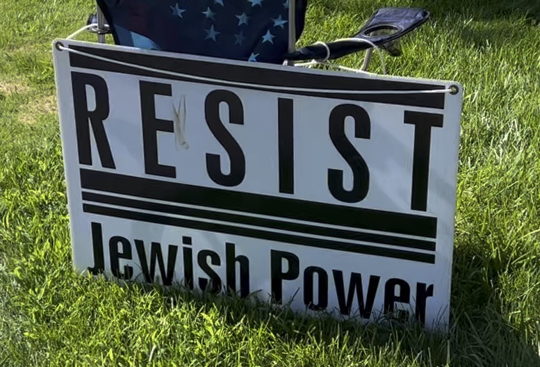 A sign displayed by anti-Jewish protestors outside a synagogue in Ann Arbor, MI (spring 2024)