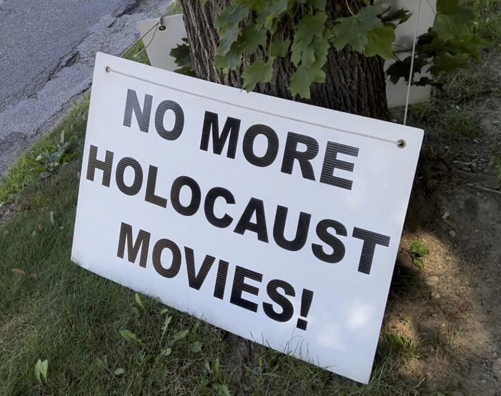 a sign reading "No More Holocaust Movies!" posted outside a synagogue in Ann Arbor, MI