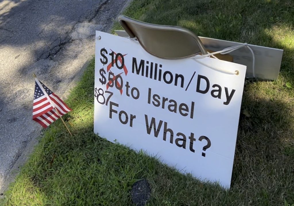 a sign reading "$XX million/Day to Israel for what?" posted outside a synagogue in Ann Arbor, MI