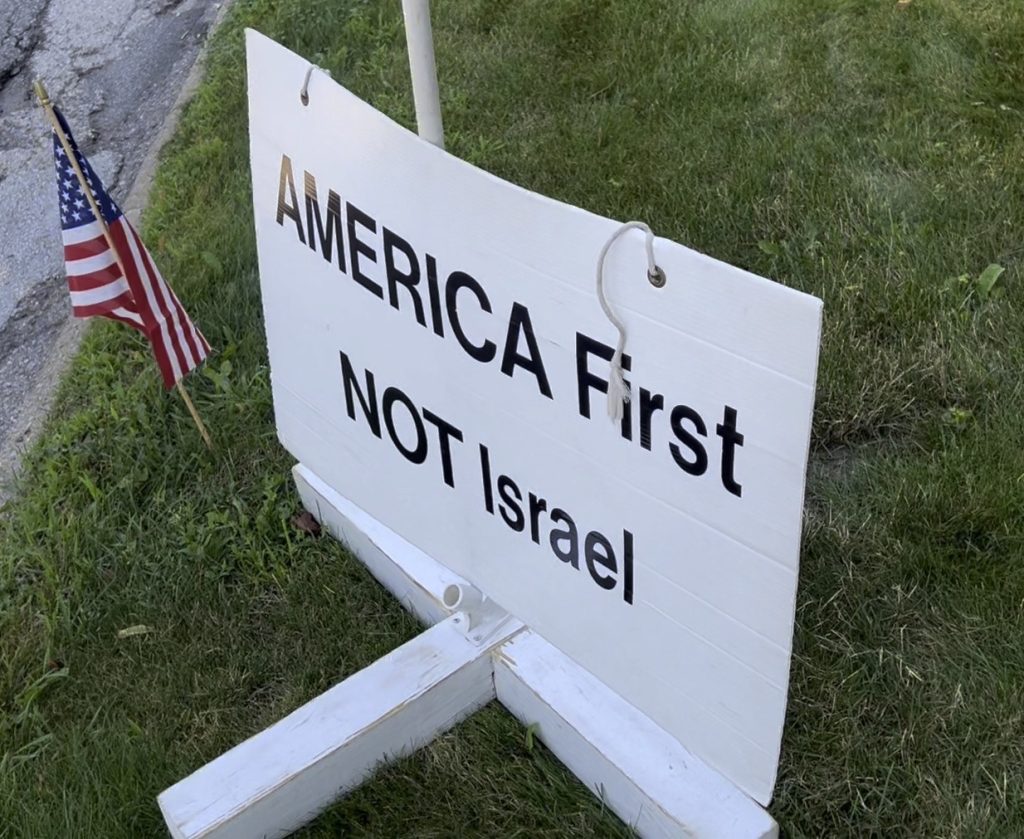 a sign reading "America First Not Israel" posted outside a synagogue in Ann Arbor, MI