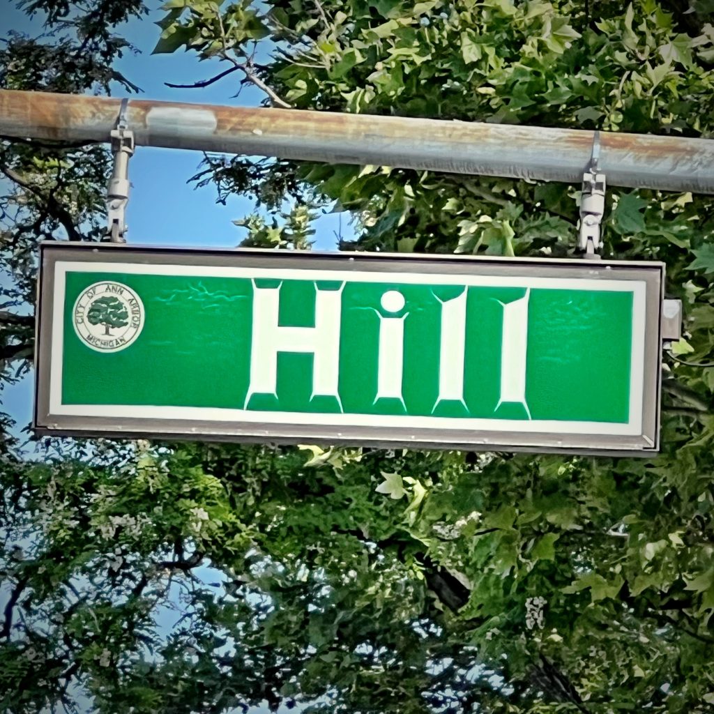 Weathered street sign for Hill street.